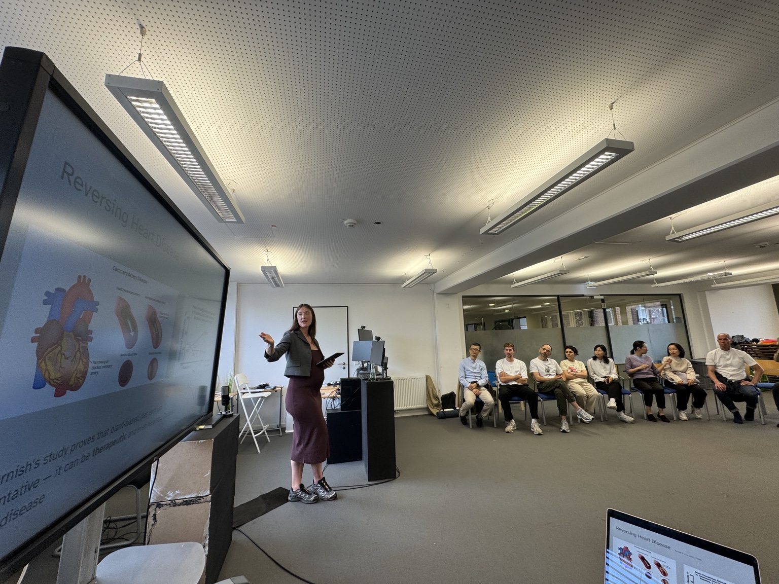 Katharina presenting a holistic health masterclass to a seated group during the MDH retreat.